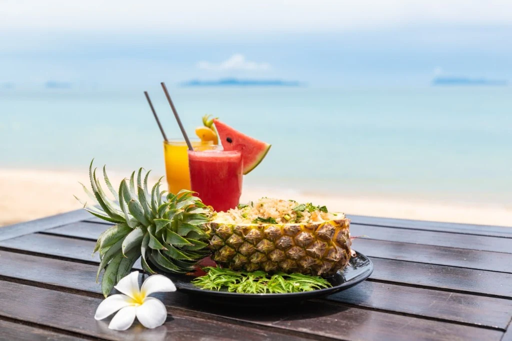 Tropical vegetarian breakfast with fresh juices on the beach