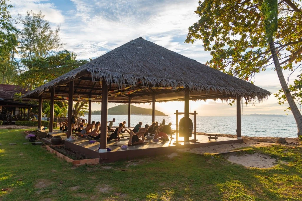 Open-air yoga deck at Satva Samui overlooking the sea at sunset
